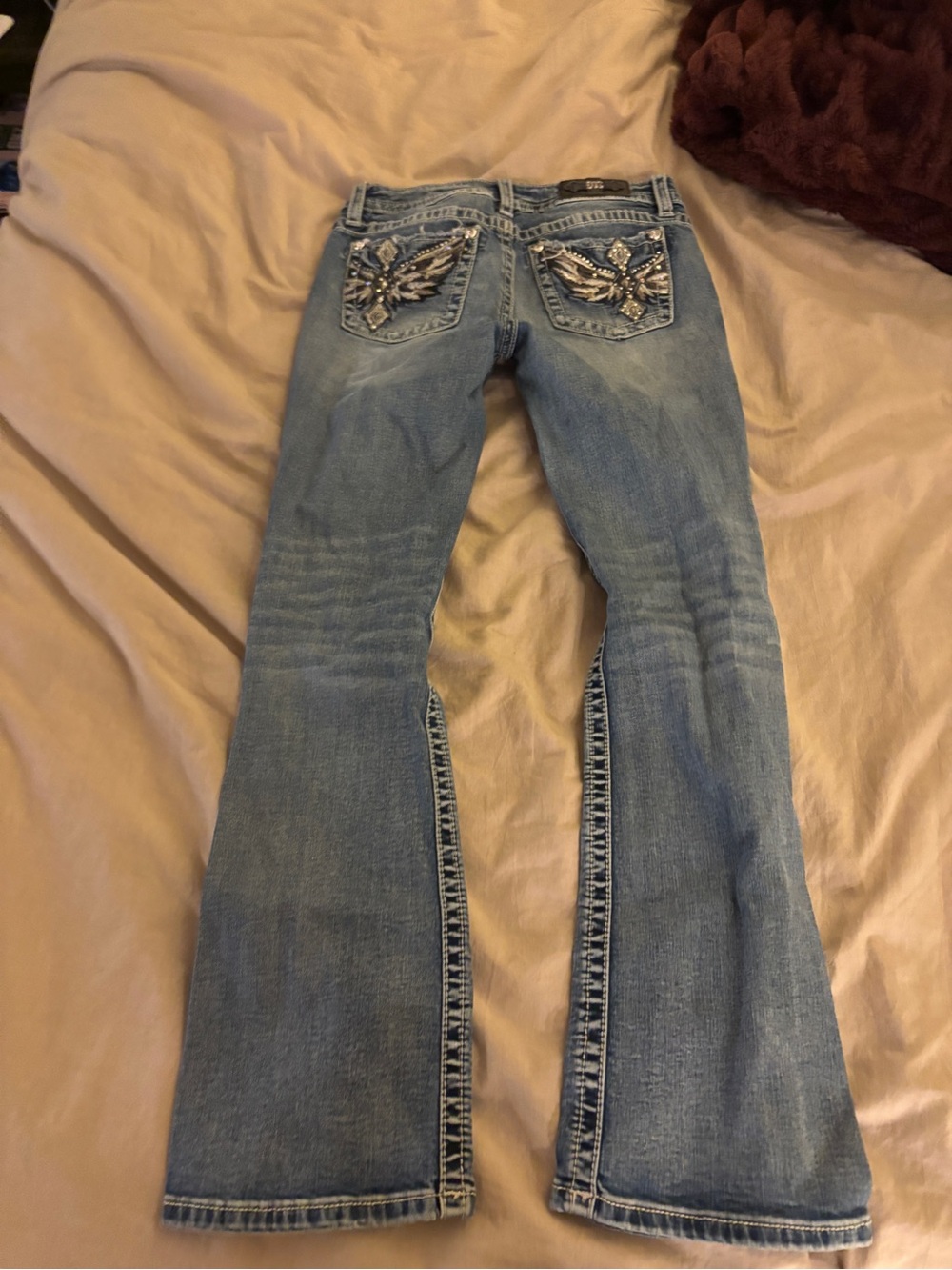 Miss Me blue bootcut jeans with rhinestone detailing. Size: 29"